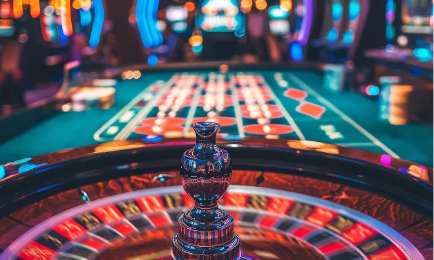 Roulette wheel mid-spin under table lights